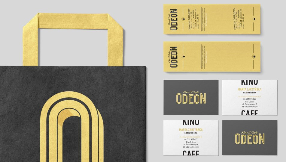 Odeon - identyfikacja wizualna przedstawiona na papierowej torbie i wizytówkach